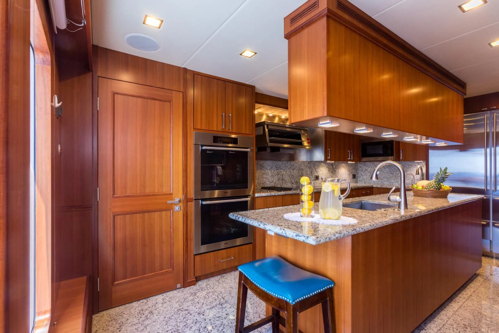 a kitchen with wooden cabinets aboard MY AURORA Yacht for Sale