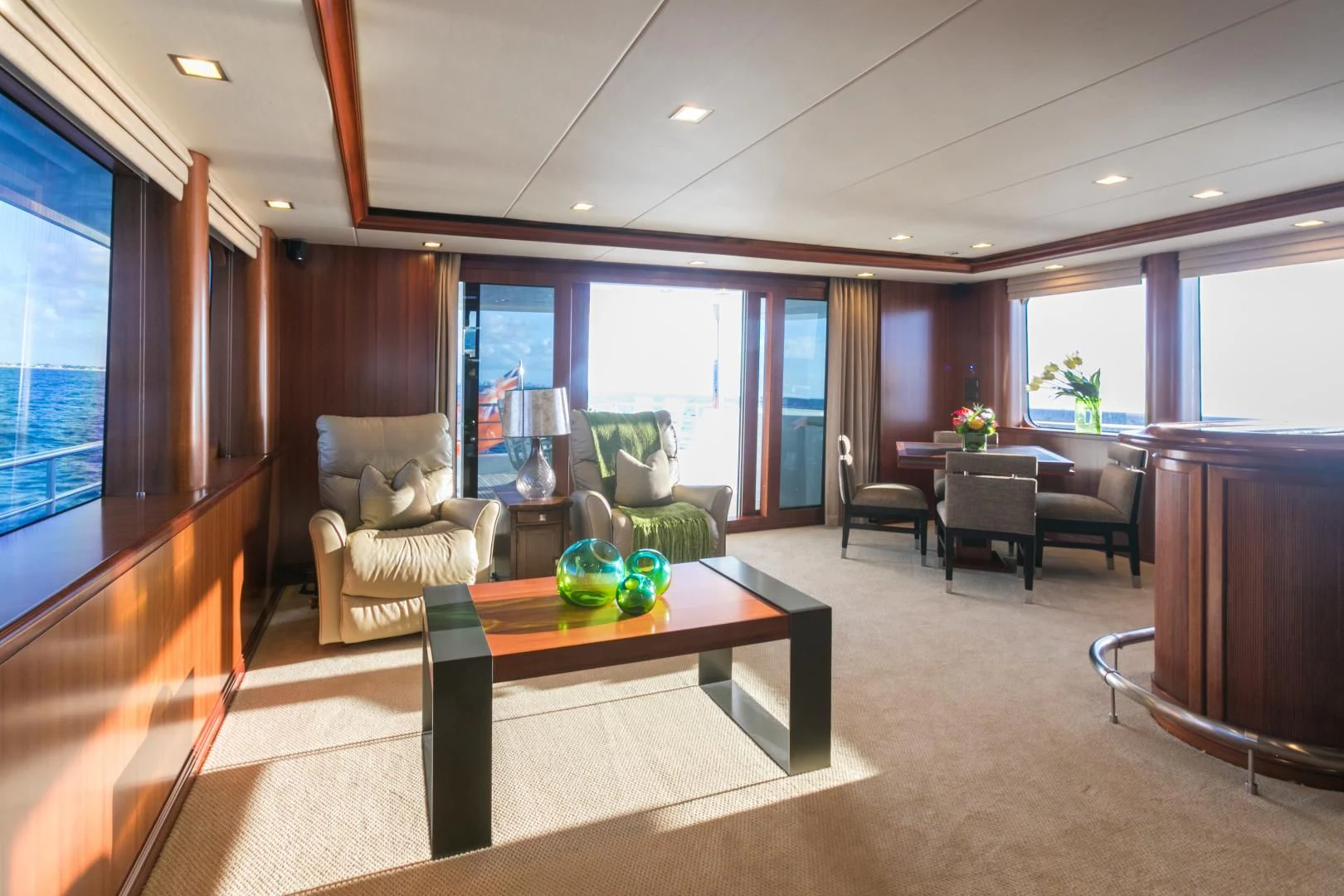 a living room with a table and chairs aboard MY AURORA Yacht for Sale