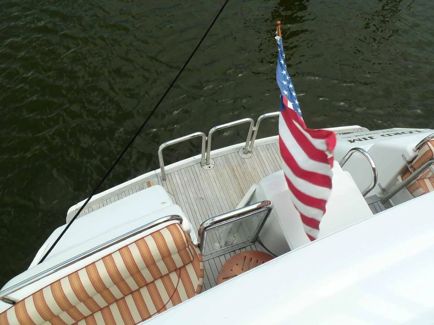 a boat with a flag on it aboard OHANA Yacht for Sale