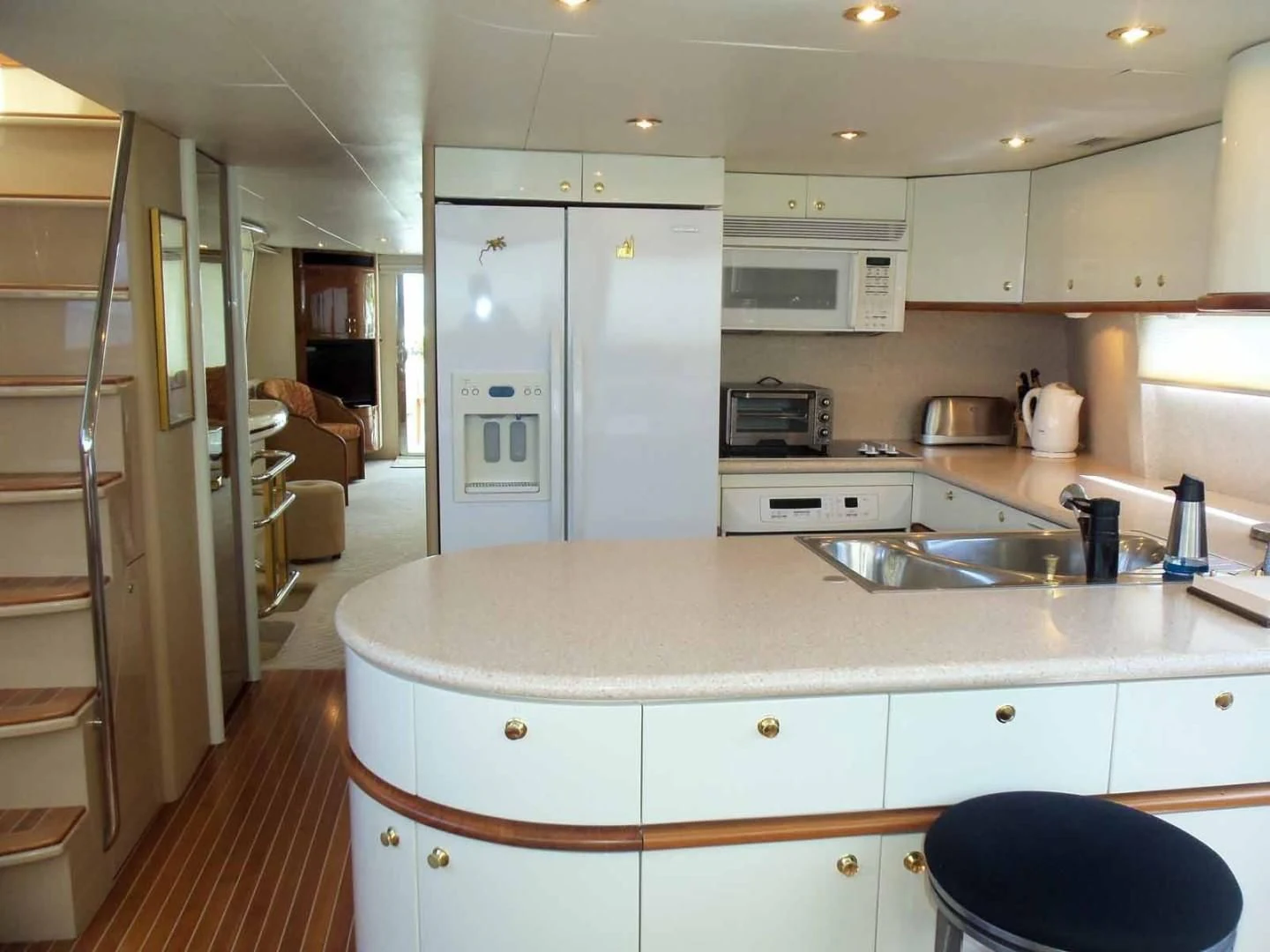 a kitchen with white cabinets aboard OHANA Yacht for Sale