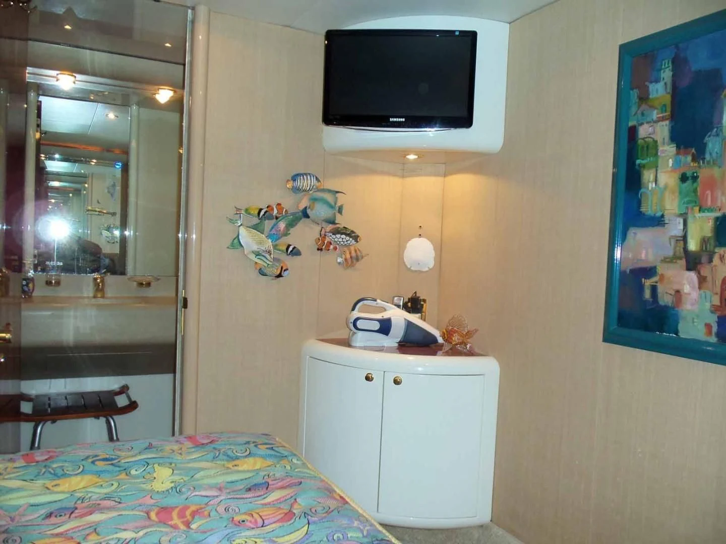 a bedroom with a television on the wall aboard OHANA Yacht for Sale