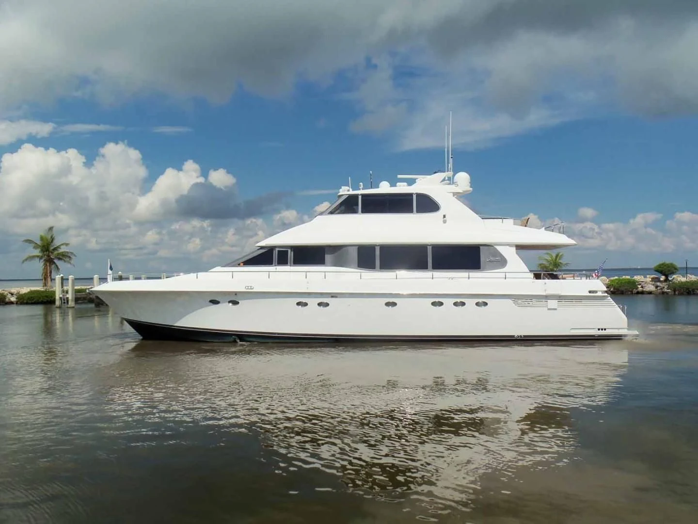 a white boat on the water aboard OHANA Yacht for Sale