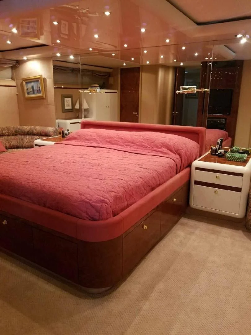 a bed with pink sheets aboard OHANA Yacht for Sale