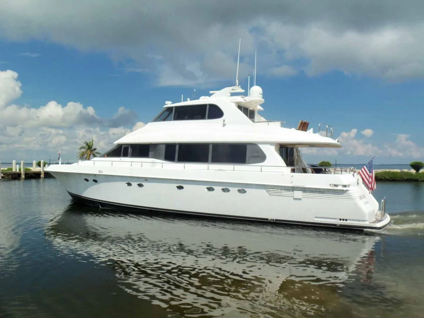a white boat on the water aboard OHANA Yacht for Sale