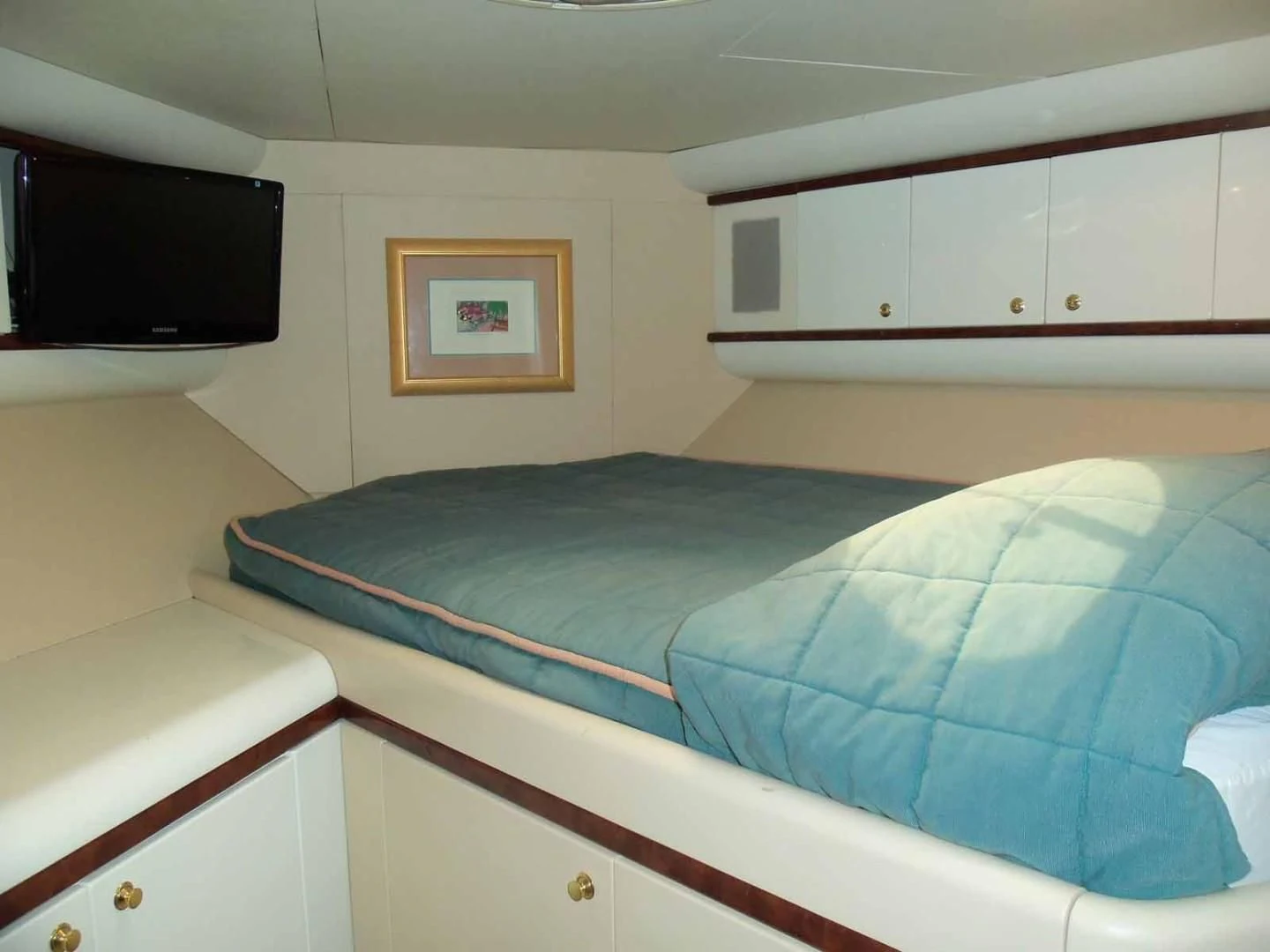 a bedroom with a bed and a television aboard OHANA Yacht for Sale