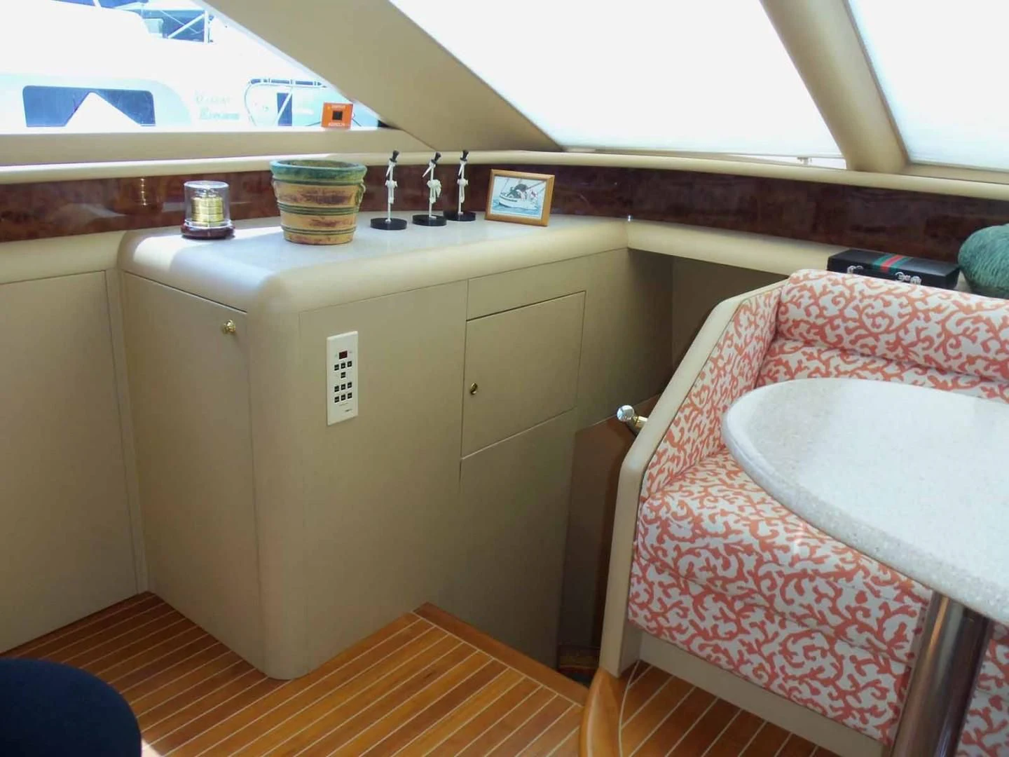 a small kitchen with a pink chair aboard OHANA Yacht for Sale