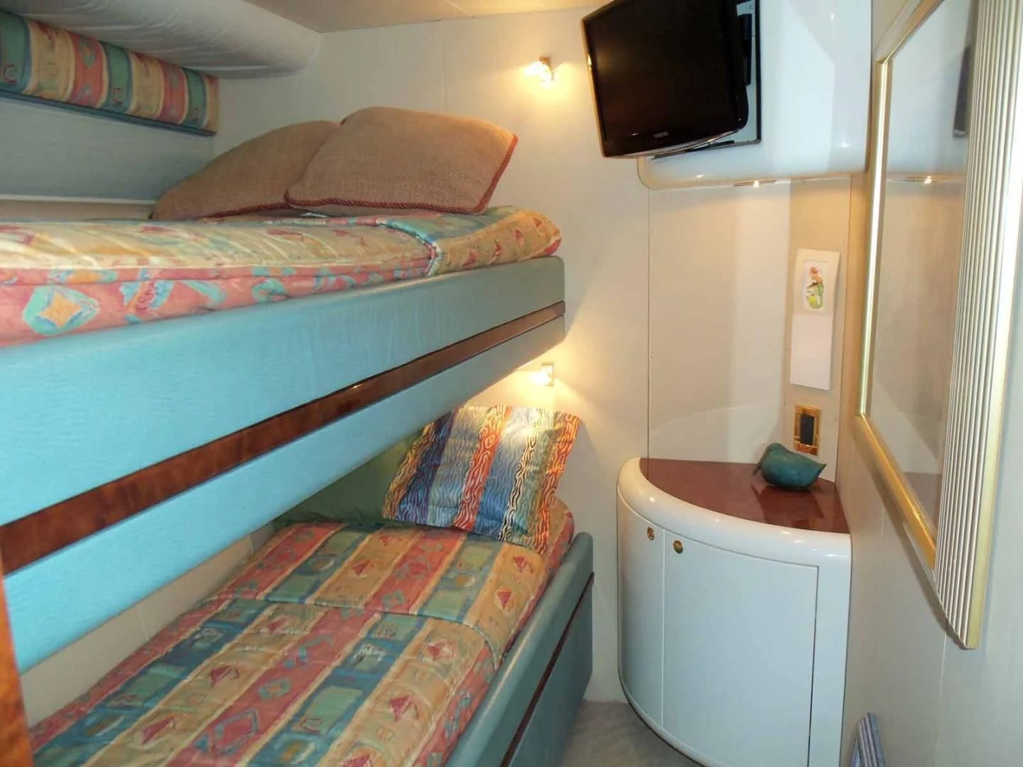 a bedroom with a bed and a television aboard OHANA Yacht for Sale