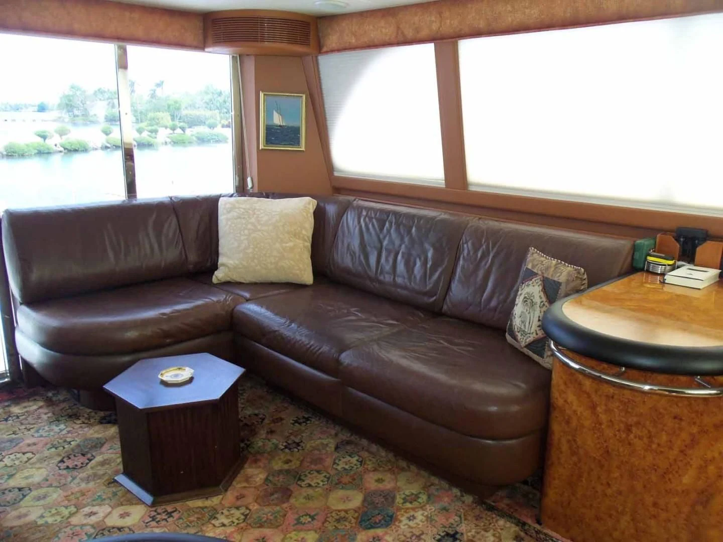 a brown leather couch in a living room aboard OHANA Yacht for Sale