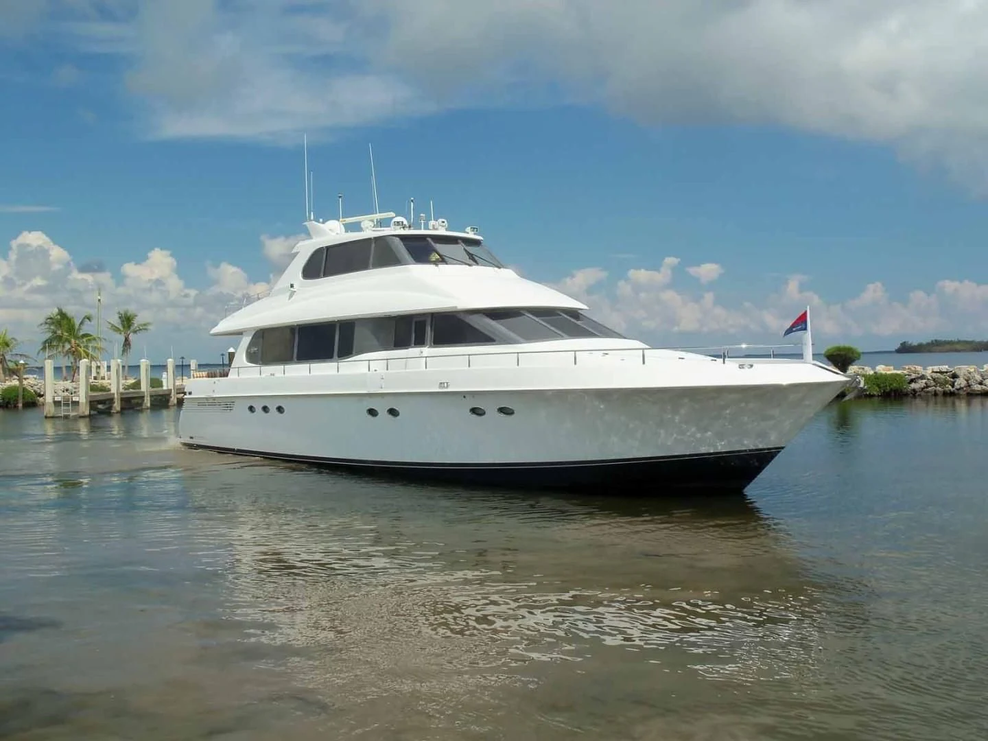 a white yacht in the water aboard OHANA Yacht for Sale