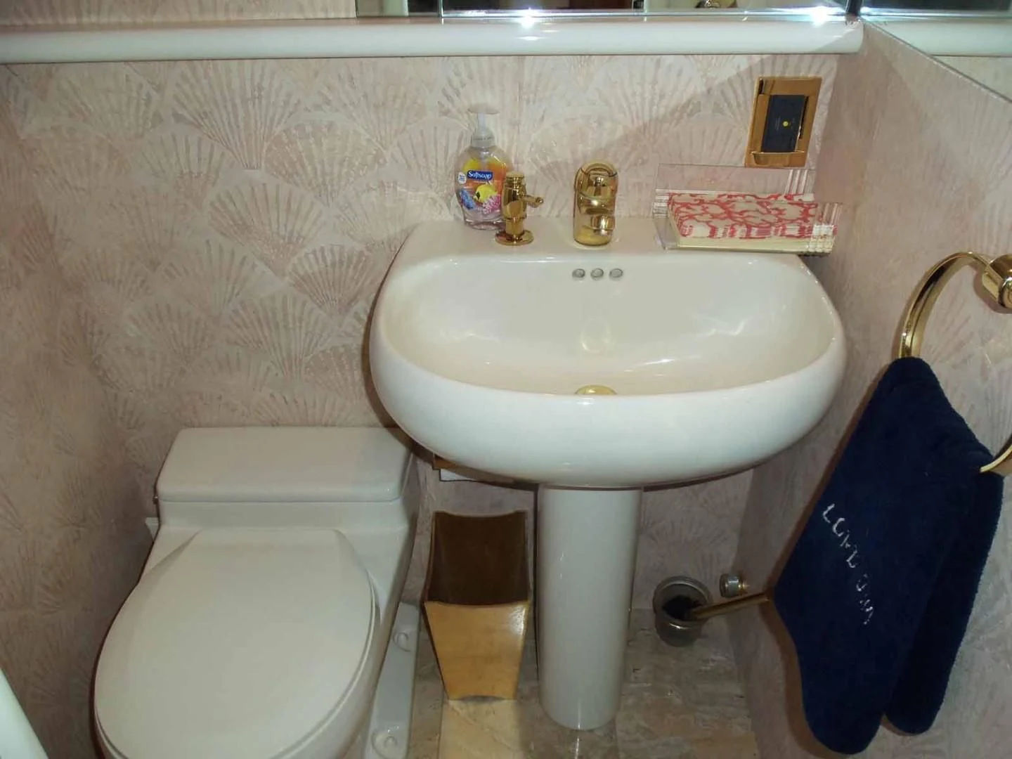 a bathroom with a toilet and sink aboard OHANA Yacht for Sale