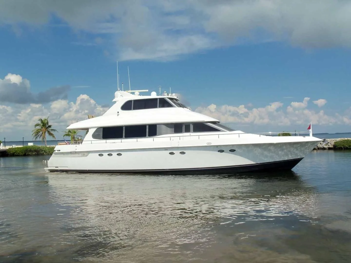 a white yacht in the water aboard OHANA Yacht for Sale