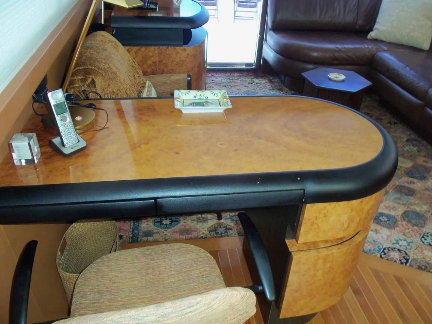 a table with a couch and a chair in the background aboard OHANA Yacht for Sale