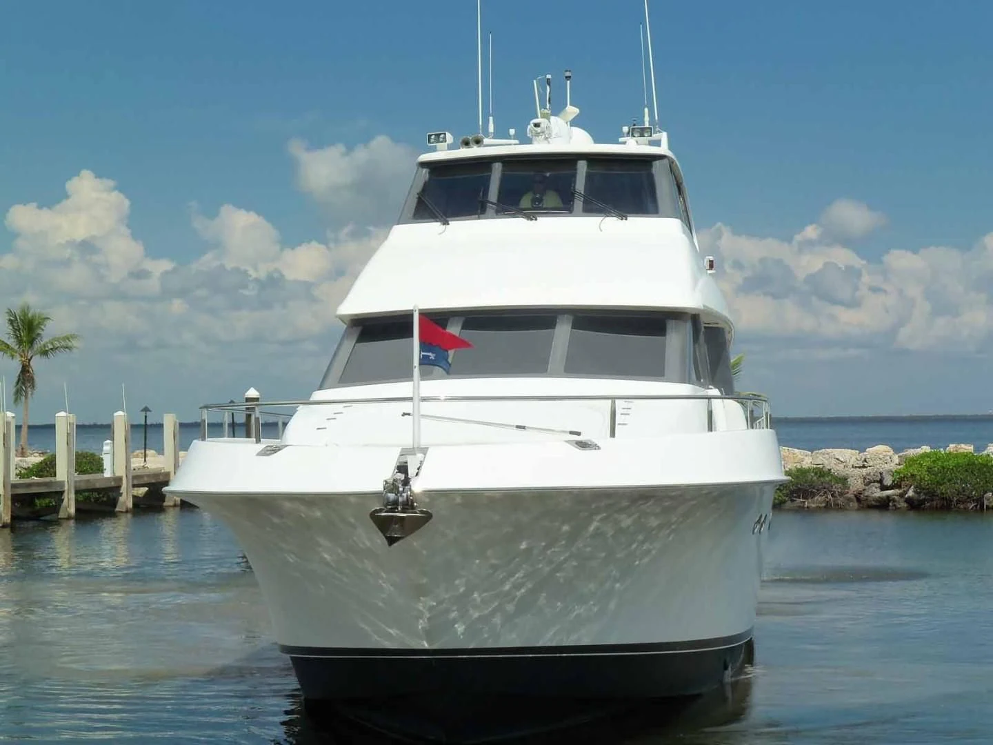 a white yacht on the water aboard OHANA Yacht for Sale