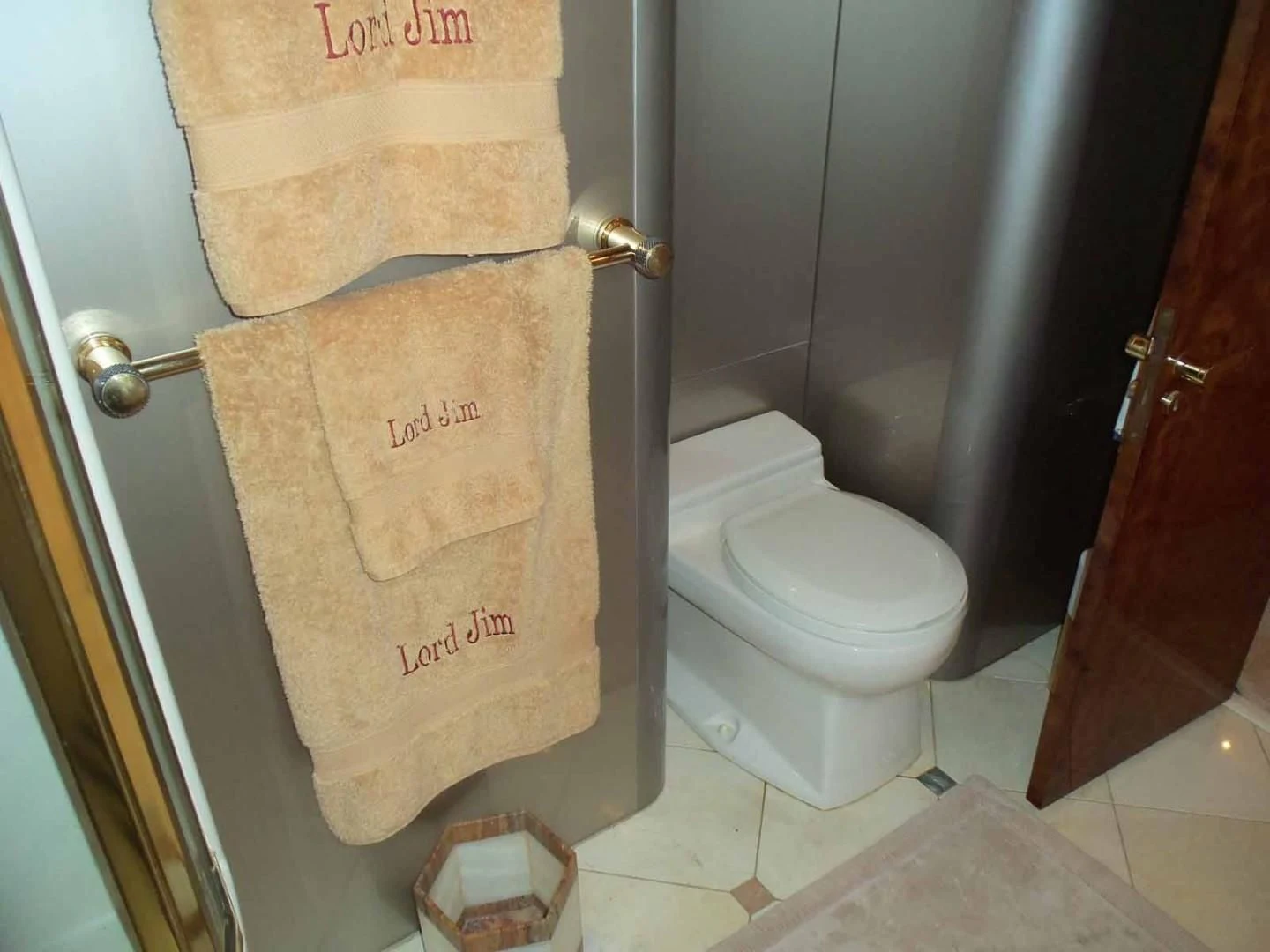a toilet with a towel on the wall aboard OHANA Yacht for Sale