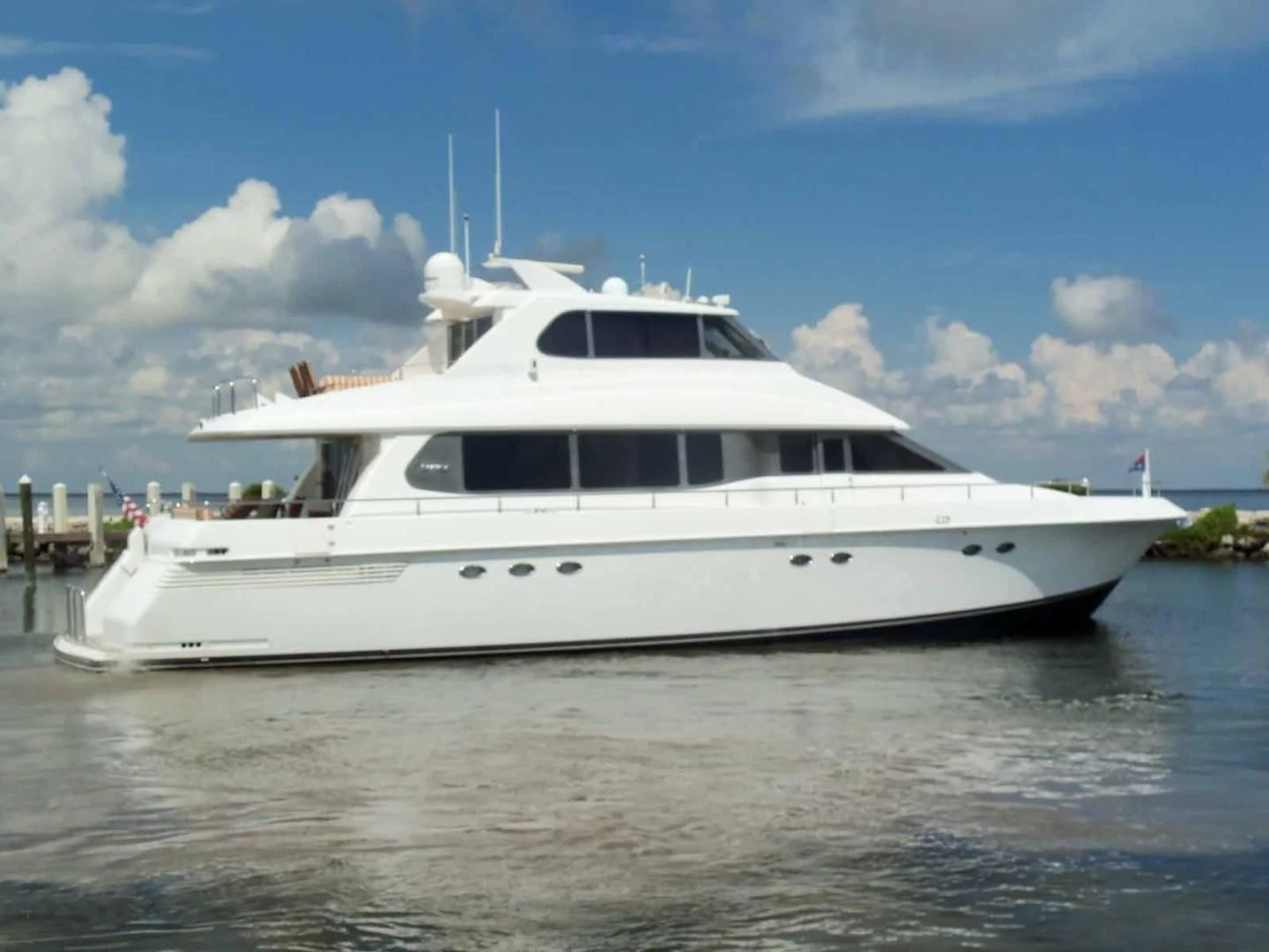 a white yacht in the water aboard OHANA Yacht for Sale