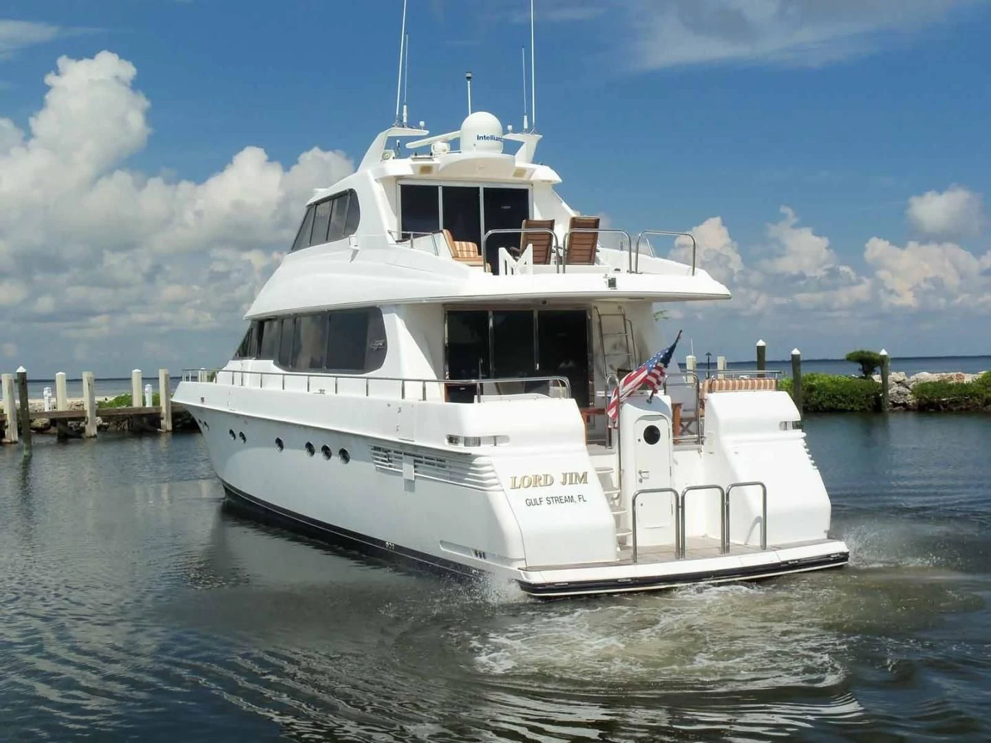 a white boat on the water aboard OHANA Yacht for Sale