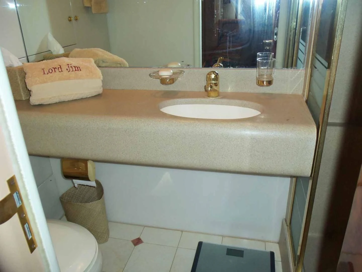 a bathroom sink with a towel and a mirror aboard OHANA Yacht for Sale