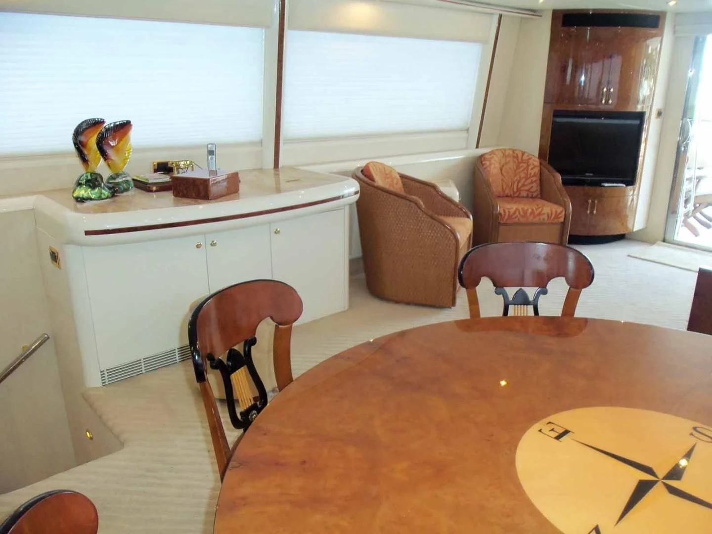 a kitchen with a table and chairs aboard OHANA Yacht for Sale