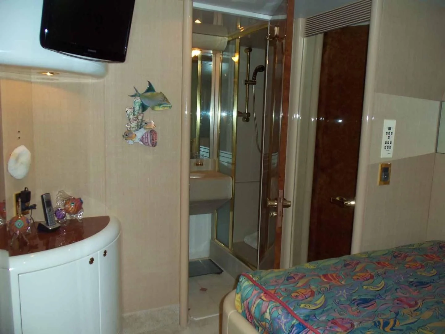 a bathroom with a shower unit and a bed aboard OHANA Yacht for Sale