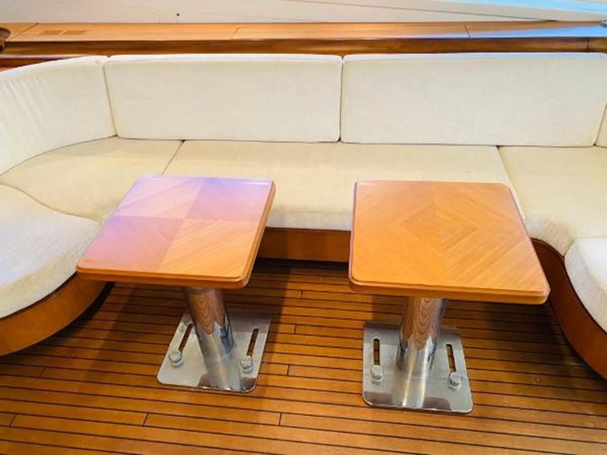 a coffee table and a glass on a coffee table aboard 2008 ARNO LEOPARD Yacht for Sale