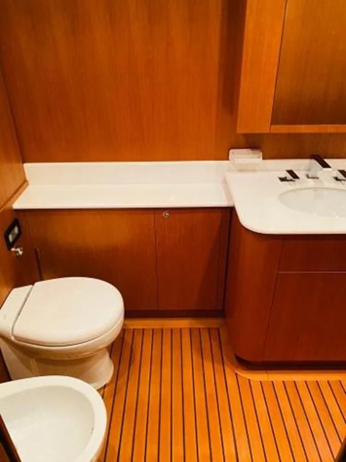 a bathroom with wooden cabinets aboard 2008 ARNO LEOPARD Yacht for Sale