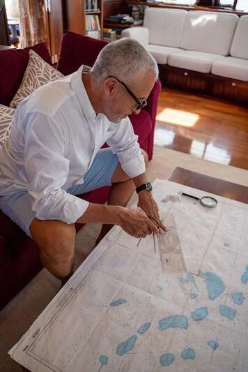 a man playing a card game aboard DOUCE FRANCE Yacht for Sale