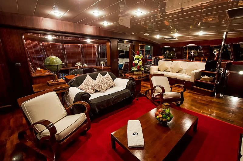 a living room with a large wood wall aboard DOUCE FRANCE Yacht for Sale