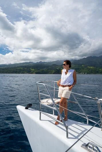 a man standing on a boat aboard DOUCE FRANCE Yacht for Sale