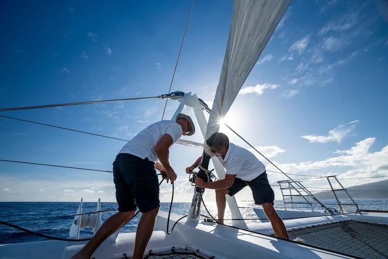 a couple of men on a sailboat aboard DOUCE FRANCE Yacht for Sale
