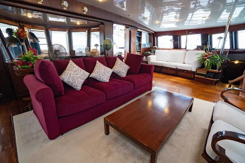 a living room with a red couch aboard DOUCE FRANCE Yacht for Sale