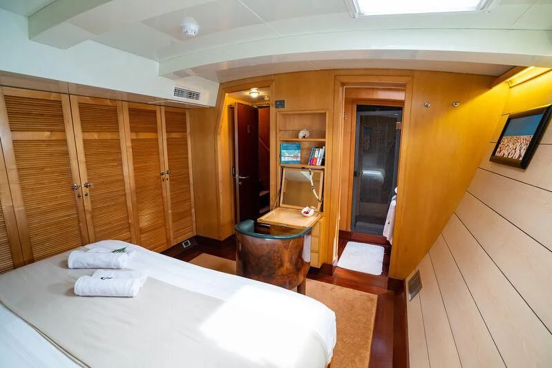 a room with a bed and a closet aboard DOUCE FRANCE Yacht for Sale
