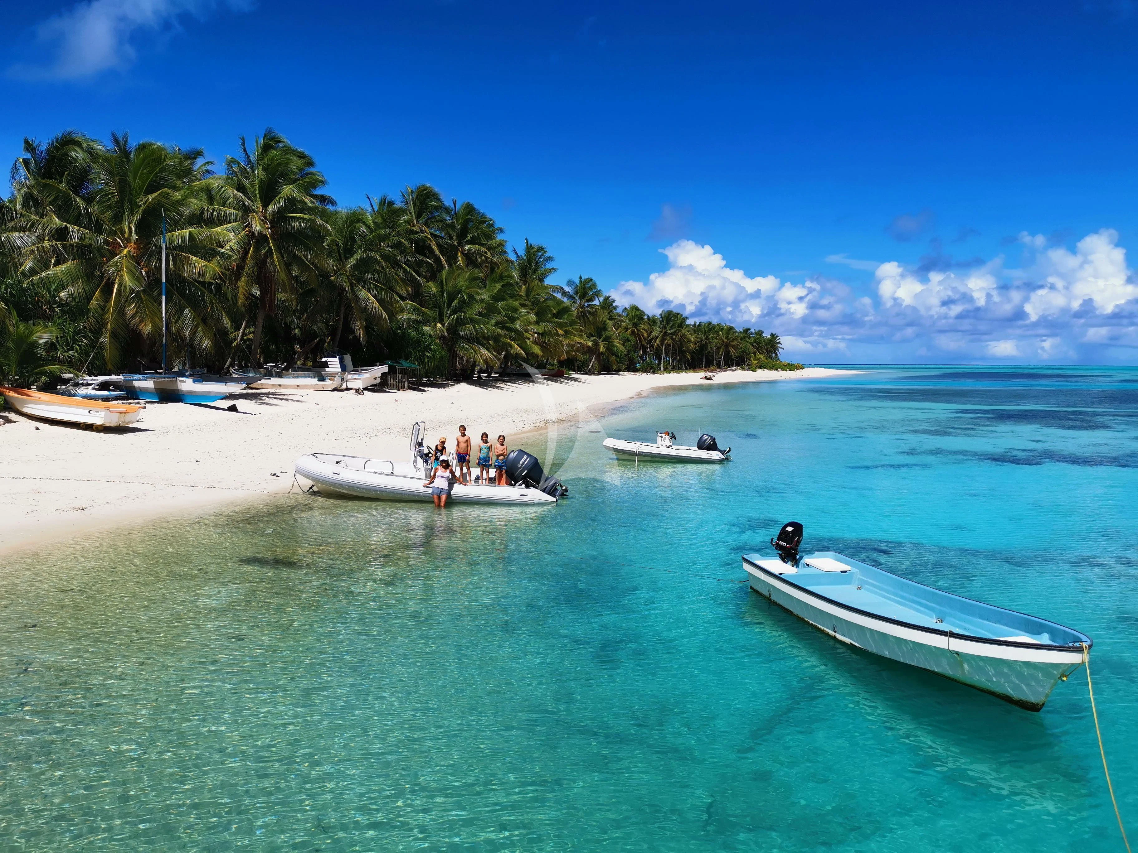a group of people on a beach aboard DOUCE FRANCE Yacht for Sale