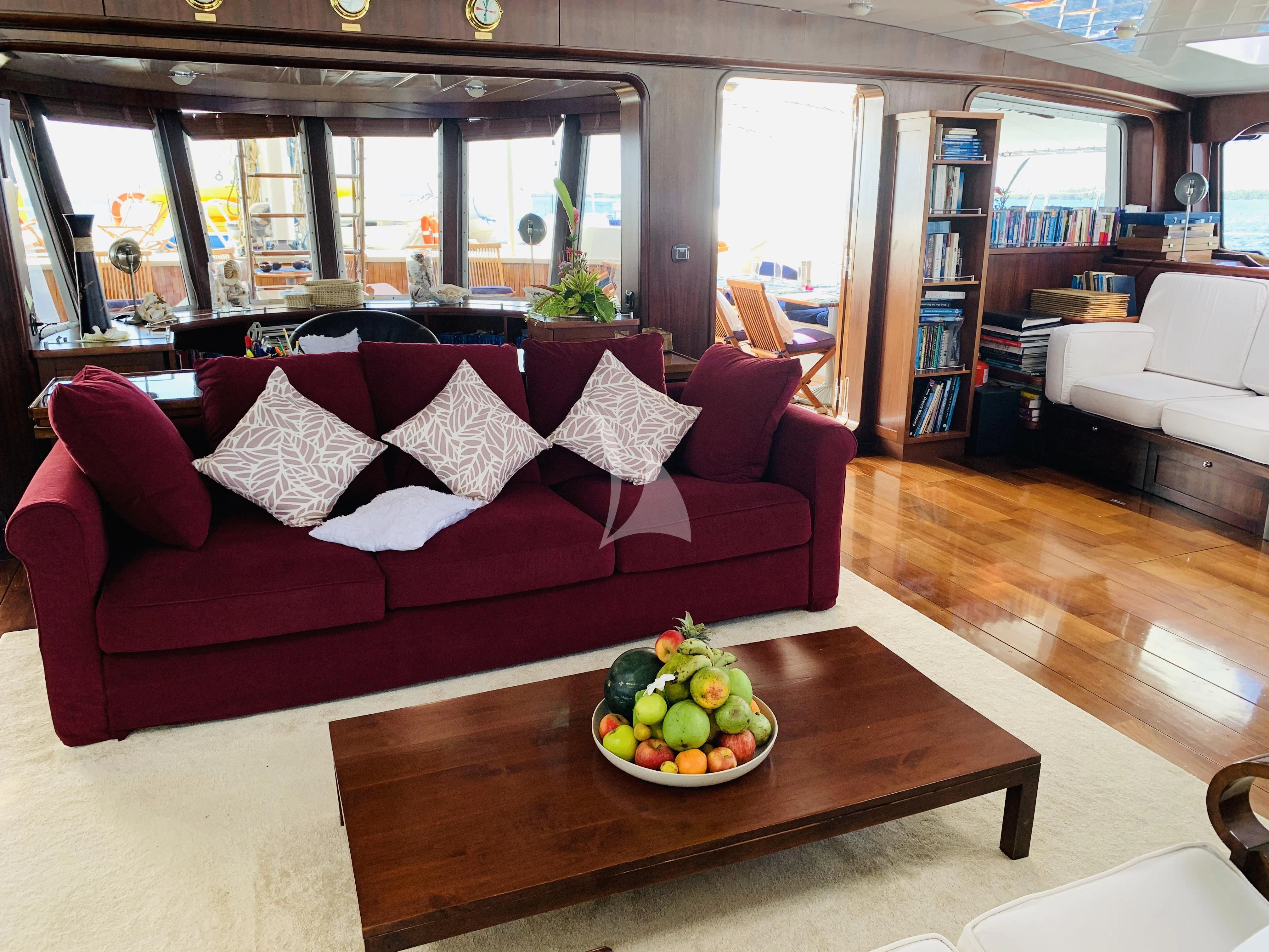 a living room with a couch and a coffee table aboard DOUCE FRANCE Yacht for Sale