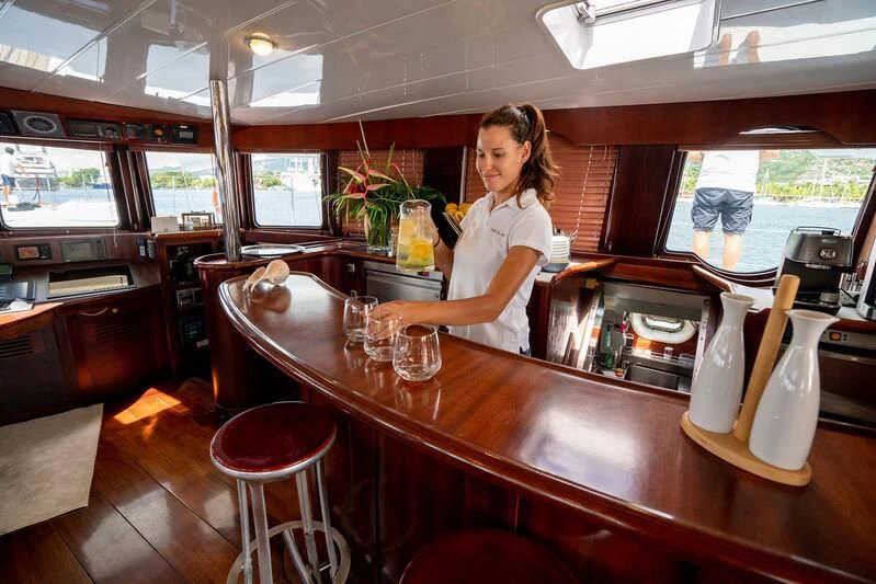 a person standing at a bar aboard DOUCE FRANCE Yacht for Sale
