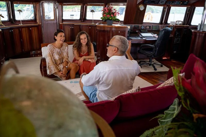 a group of people sitting in a room aboard DOUCE FRANCE Yacht for Sale