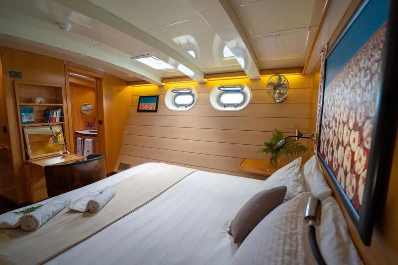 a room with a bed and a desk aboard DOUCE FRANCE Yacht for Sale