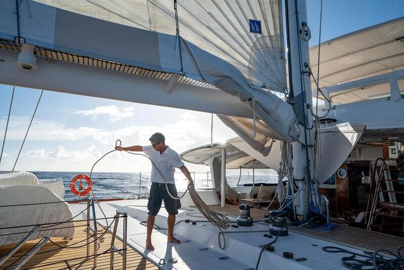 a man standing on a boat aboard DOUCE FRANCE Yacht for Sale