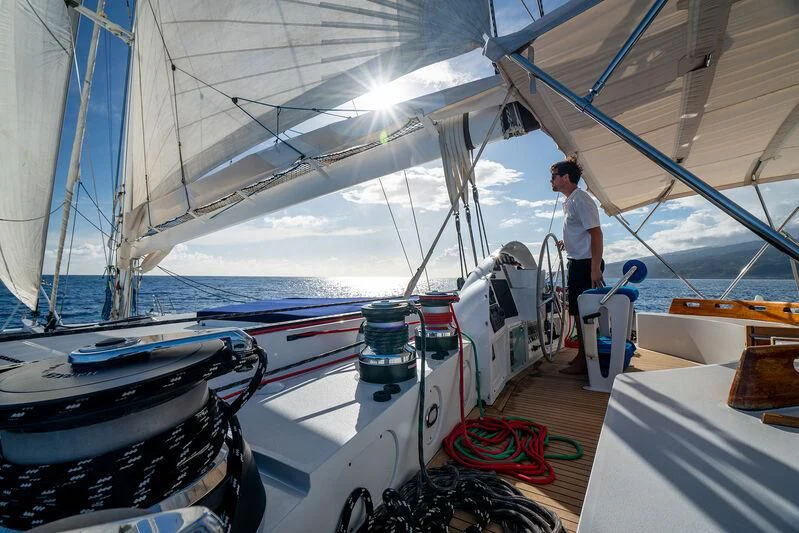 a person standing on a boat aboard DOUCE FRANCE Yacht for Sale