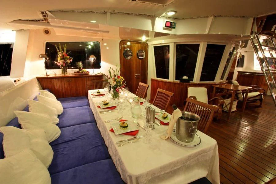 a room with tables and chairs aboard DOUCE FRANCE Yacht for Sale