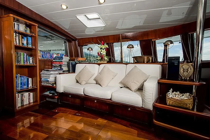 a living room with a couch and bookshelves aboard DOUCE FRANCE Yacht for Sale