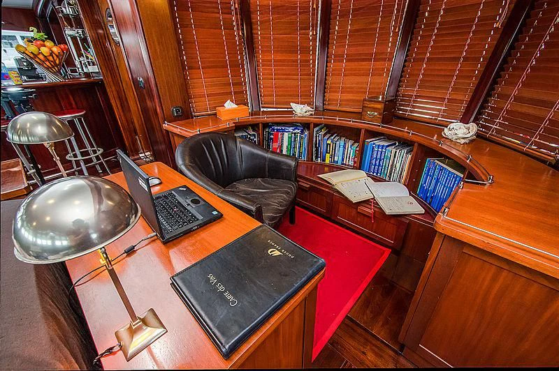 a laptop on a table aboard DOUCE FRANCE Yacht for Sale