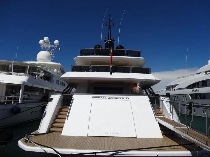 a large white boat with a couple of boats on it aboard PARAM JAMUNA IV Yacht for Sale