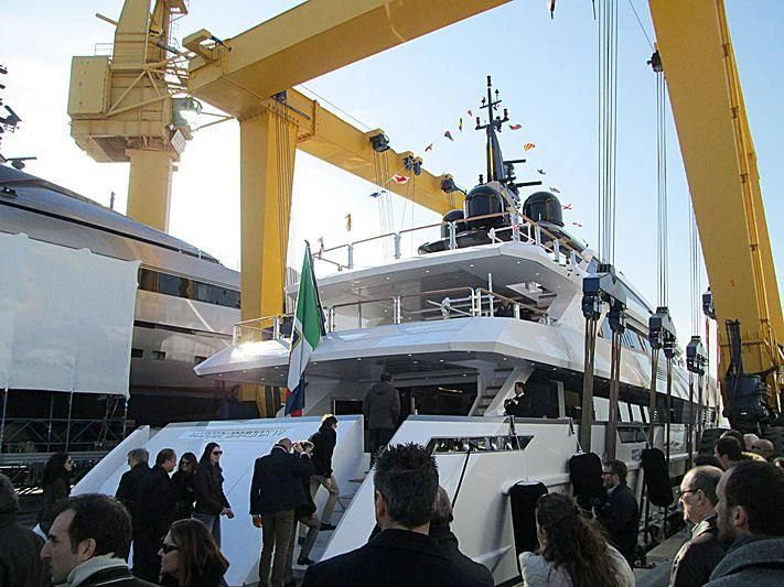 a group of people standing around a boat aboard PARAM JAMUNA IV Yacht for Sale