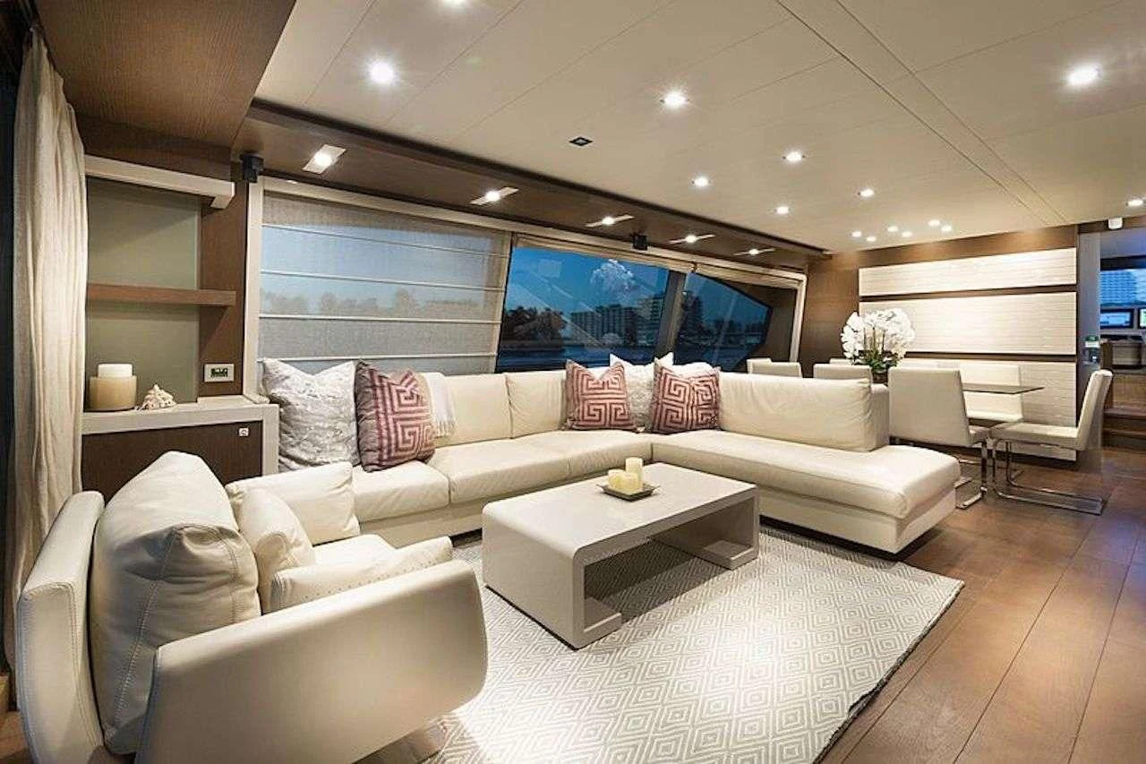 a living room with a large white couch and a table aboard HOYA SAXA Yacht for Sale