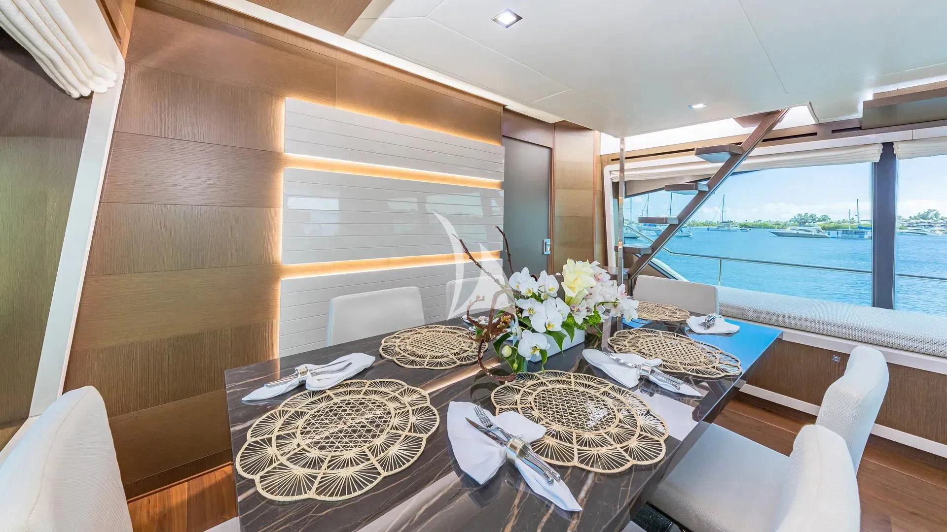 a dining table with plates and a basket of flowers on it aboard HOYA SAXA Yacht for Sale