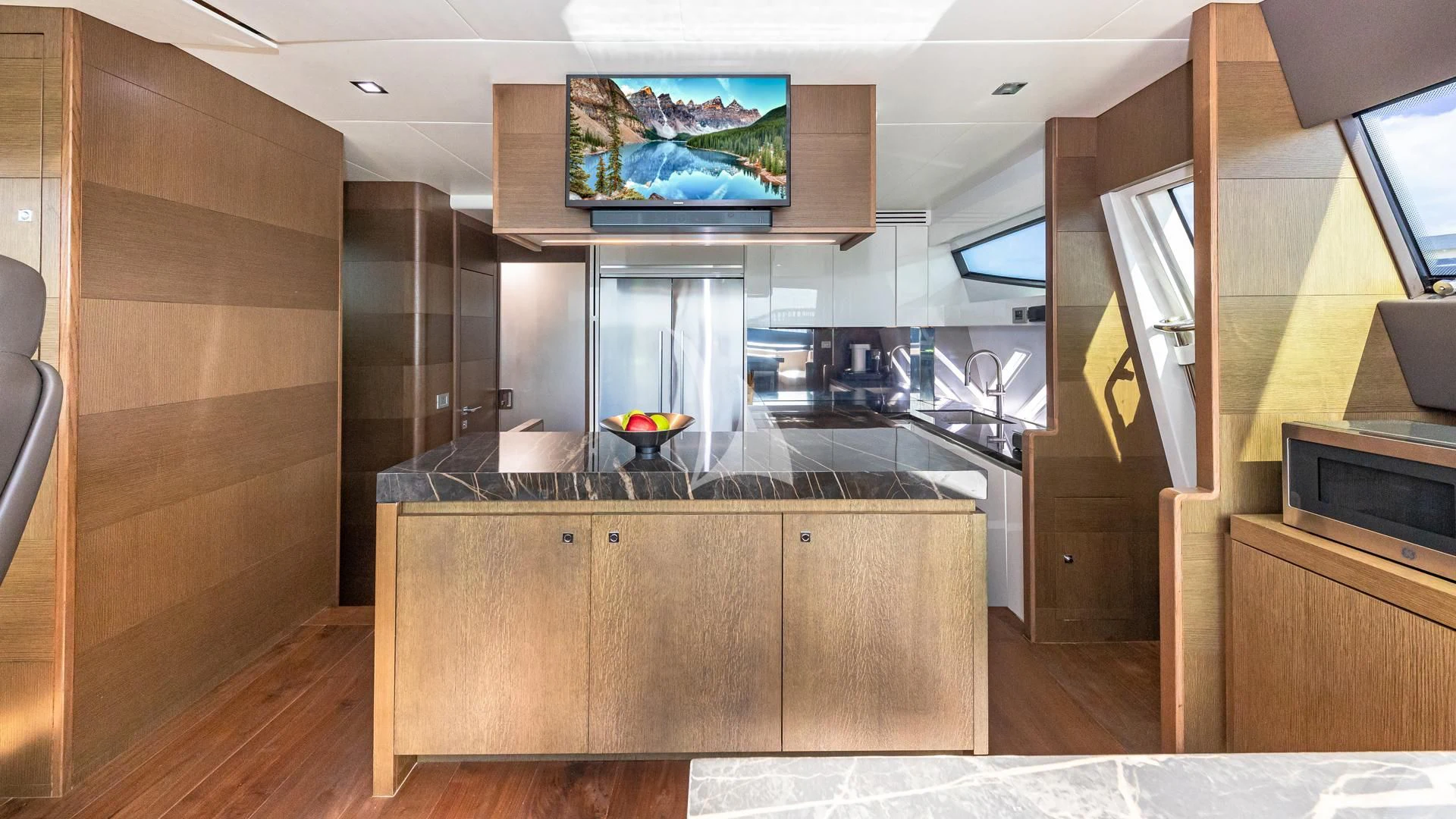 a kitchen with a tv on the wall aboard HOYA SAXA Yacht for Sale