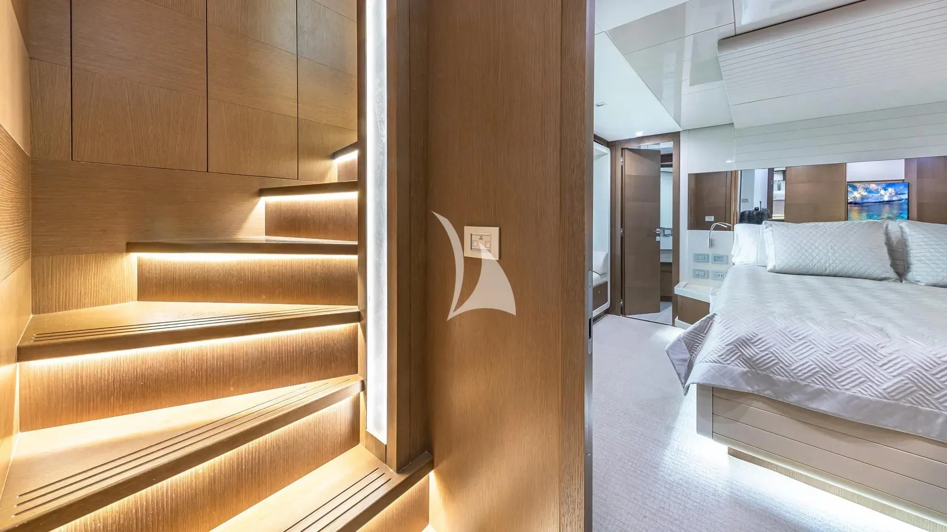 a room with a bed and a door aboard HOYA SAXA Yacht for Sale