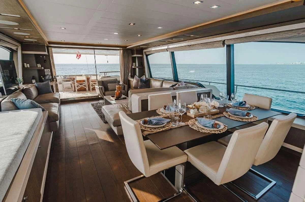 a dining room with a large window overlooking the ocean aboard HOYA SAXA Yacht for Sale