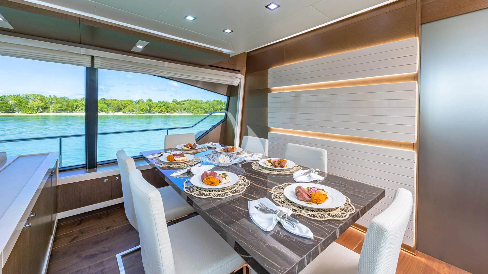 a table with plates and food on it aboard HOYA SAXA Yacht for Sale