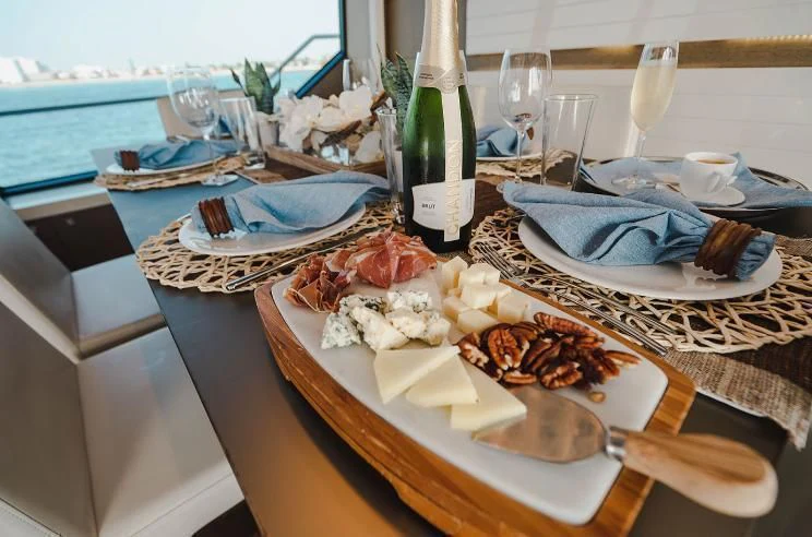 a table with plates and glasses aboard HOYA SAXA Yacht for Sale